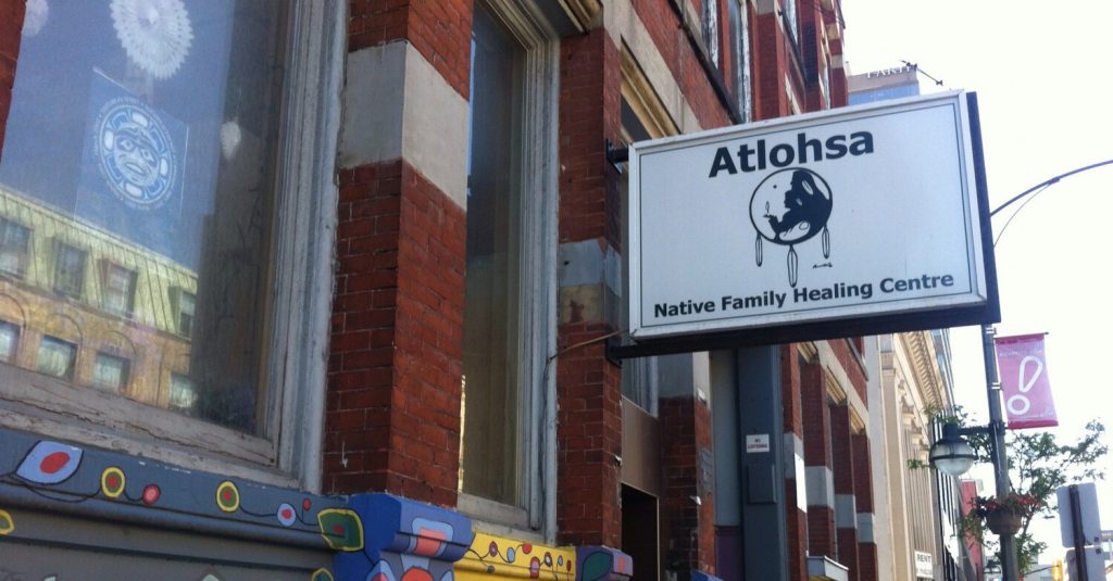 A photo of the Atlohsa Native Family Healing Centre sign outside of the building. 